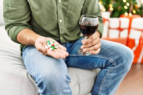 Young Hispanic Man Holding Glass Wine Pills Sitting Sofa Dog — Foto de Stock