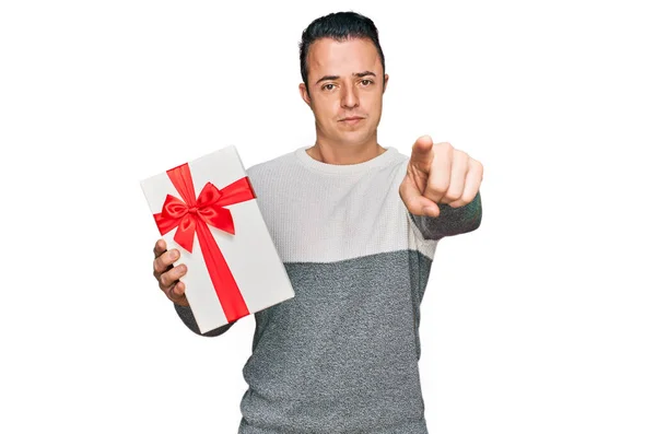 Handsome Young Man Holding Gift Pointing Finger Camera You Confident — Stockfoto