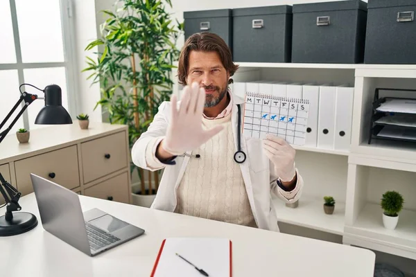 Handsome Middle Age Doctor Man Holding Holidays Calendar Open Hand —  Fotos de Stock