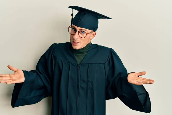 Young Caucasian Man Wearing Graduation Cap Ceremony Robe Clueless Confused — Fotografia de Stock