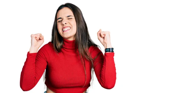 Young Brunette Teenager Wearing Red Turtleneck Sweater Excited Success Arms — стоковое фото