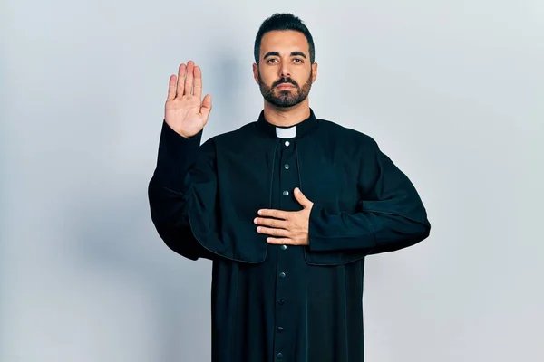 Handsome Hispanic Man Beard Wearing Catholic Priest Robe Swearing Hand — Stock Photo, Image