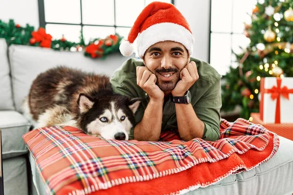 Young Hispanic Man Smiling Confident Lying Sofa Dog Christmas Tree — Fotografia de Stock