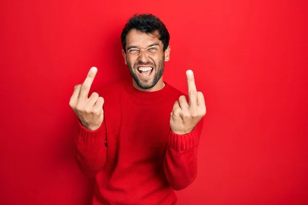 Handsome Man Beard Wearing Casual Red Sweater Showing Middle Finger — Stok fotoğraf