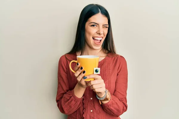 Young Hispanic Woman Holding Cup Tea Winking Looking Camera Sexy — ストック写真