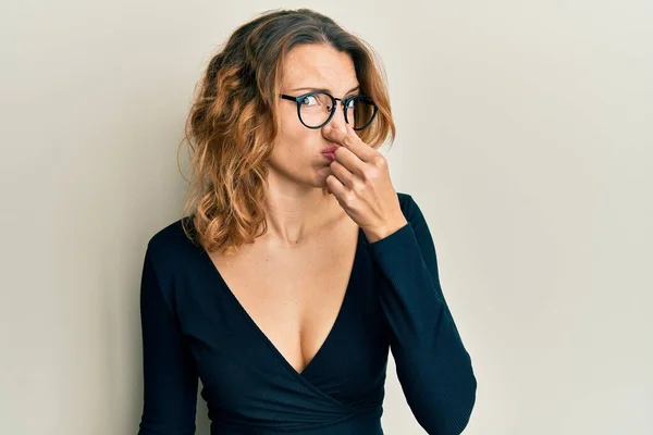 Young Caucasian Woman Wearing Business Shirt Glasses Smelling Something Stinky — Stock Photo, Image