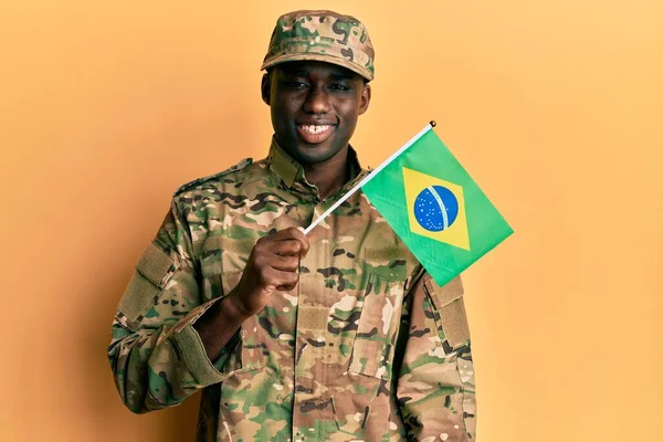 Young African American Man Wearing Army Uniform Holding Brazil Flag —  Fotos de Stock