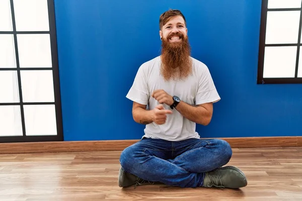 Redhead Man Long Beard Sitting Floor Empty Room Big Smile — Foto Stock