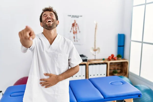 Young Handsome Physiotherapist Man Working Pain Recovery Clinic Laughing You — Stockfoto