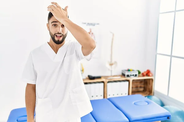 Young Handsome Man Beard Working Pain Recovery Clinic Surprised Hand — Fotografia de Stock