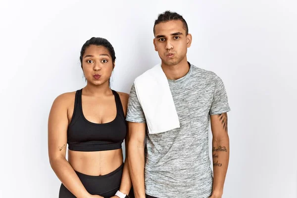 Young Latin Couple Wearing Sportswear Standing Isolated Background Puffing Cheeks — Stock fotografie