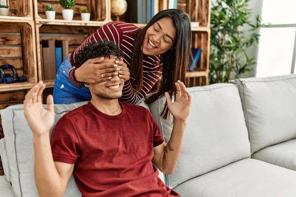 Woman Surprising Her Boyfriend Hands Eyes Sitting Sofa Home — Stock Photo, Image