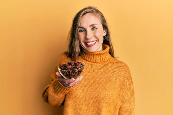 Young Blonde Woman Holding Bowl Star Anise Looking Positive Happy — Fotografia de Stock