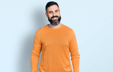 Hispanic man with beard wearing casual winter sweater with a happy and cool smile on face. lucky person. 