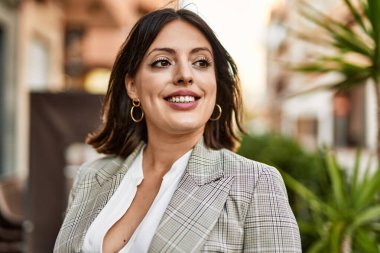 Genç İspanyol iş kadını şehirde mutlu mesut ayakta duruyor..