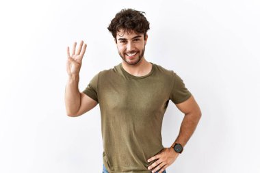 Hispanic man standing over isolated white background showing and pointing up with fingers number four while smiling confident and happy. 