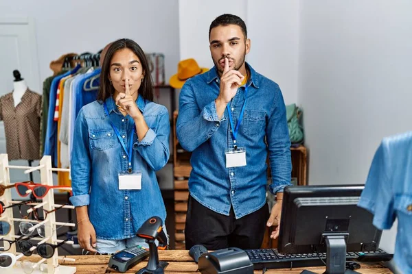 Young Interracial People Working Retail Boutique Asking Quiet Finger Lips —  Fotos de Stock