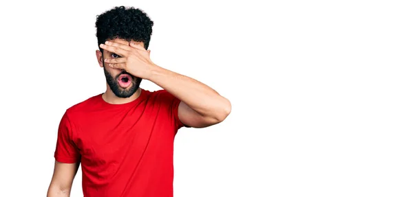 Young Arab Man Beard Wearing Casual Red Shirt Peeking Shock — 스톡 사진