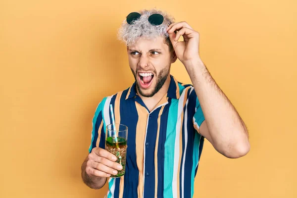 Young Hispanic Man Modern Dyed Hair Drinking Mojito Glass Angry — Zdjęcie stockowe