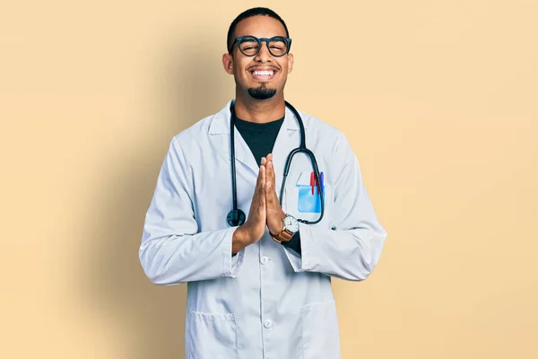 Young African American Man Wearing Doctor Uniform Stethoscope Praying Hands — Foto de Stock