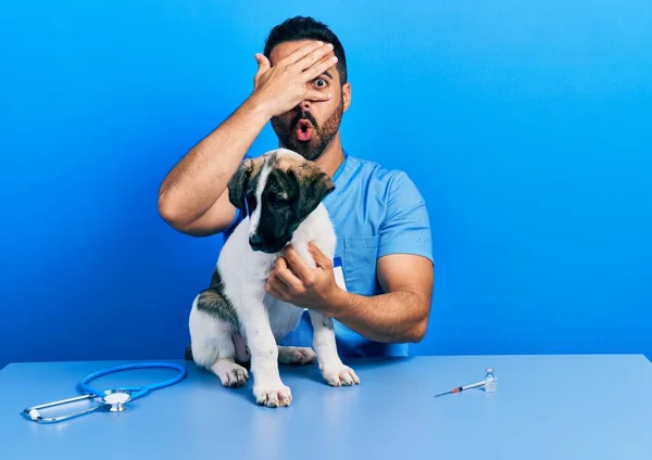 Handsome Hispanic Veterinary Man Beard Checking Dog Health Peeking Shock — стоковое фото