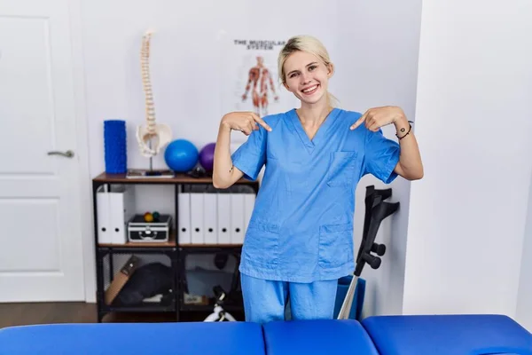 Young Physiotherapist Woman Working Pain Recovery Clinic Looking Confident Smile —  Fotos de Stock