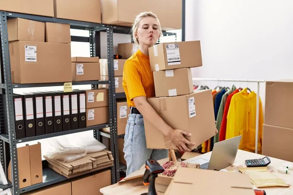 Young Blonde Woman Working Small Business Ecommerce Making Fish Face — Stok fotoğraf