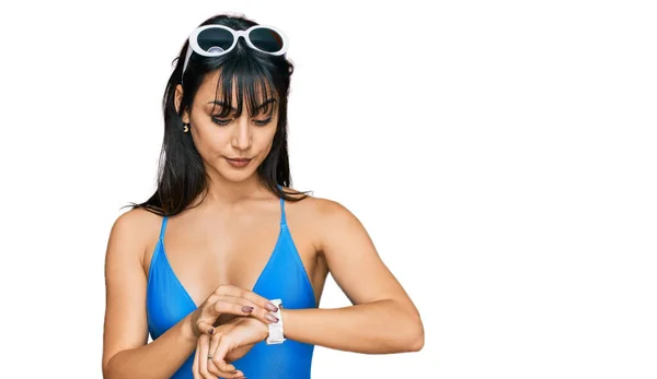 Young Hispanic Woman Wearing Swimsuit Sunglasses Checking Time Wrist Watch — Stockfoto