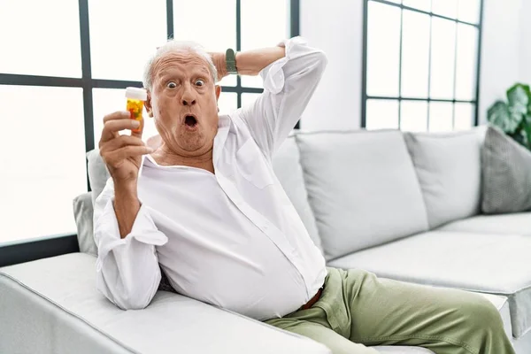 Senior Man Holding Pills Crazy Scared Hands Head Afraid Surprised — Stock fotografie