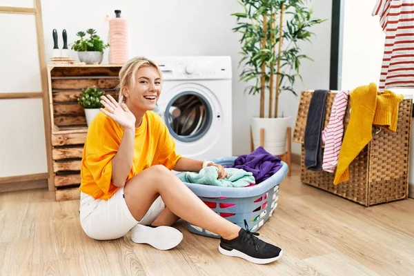 Young Caucasian Woman Putting Dirty Laundry Washing Machine Waiving Saying — Stockfoto