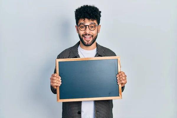 Young Arab Man Beard Holding Blackboard Celebrating Crazy Amazed Success — Stock Fotó
