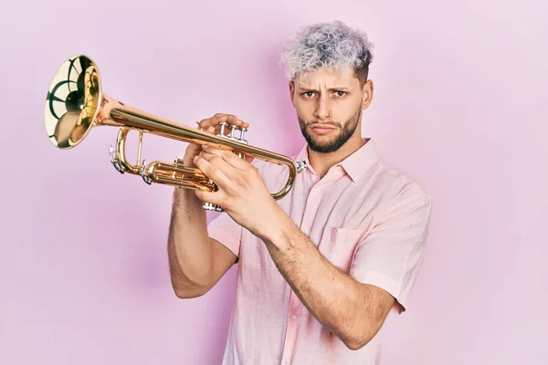 Young Hispanic Man Modern Dyed Hair Playing Trumpet Depressed Worry — Zdjęcie stockowe