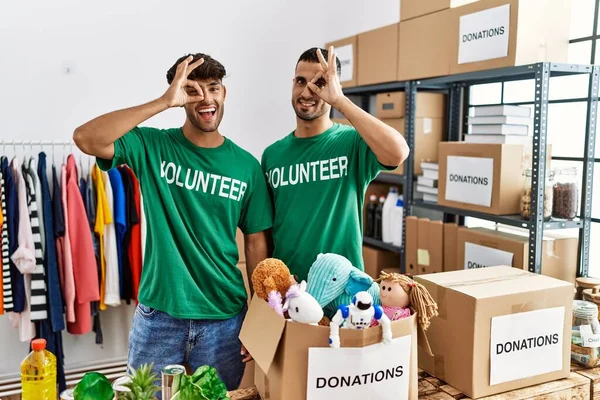 Young Gay Couple Wearing Volunteer Shirt Donations Stand Doing Gesture —  Fotos de Stock