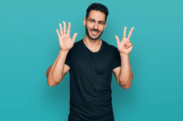 Hispanic Man Beard Wearing Casual Black Shirt Showing Pointing Fingers — Stockfoto