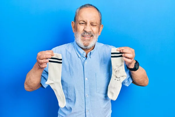 Handsome Senior Man Beard Holding Clean Andy Dirty Socks Winking — Fotografia de Stock