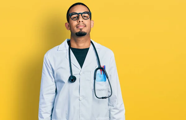 Young African American Man Wearing Doctor Uniform Stethoscope Relaxed Serious — стоковое фото