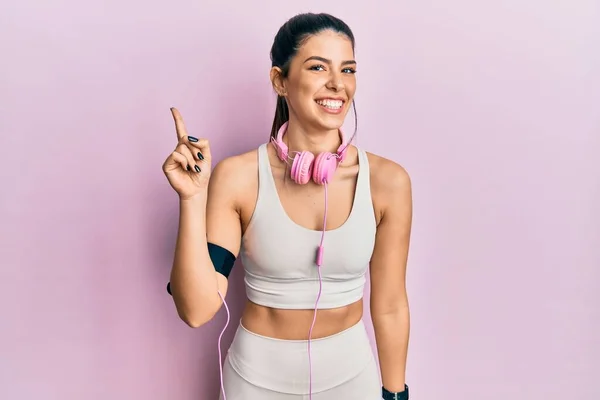 Young Hispanic Woman Wearing Gym Clothes Using Headphones Big Smile — стоковое фото