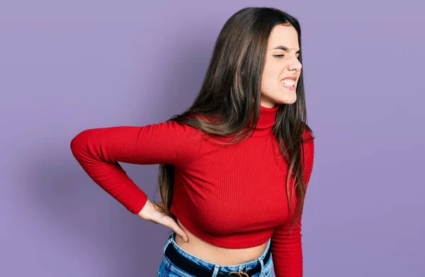 Young Brunette Teenager Wearing Red Turtleneck Sweater Suffering Backache Touching — Stockfoto