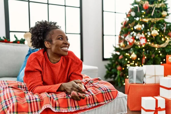 Young African American Woman Lying Sofa Christmas Tree Looking Away — Stockfoto