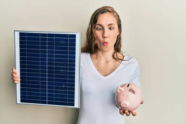 Young Blonde Woman Holding Photovoltaic Solar Panel Piggy Bank Making — Stock Fotó