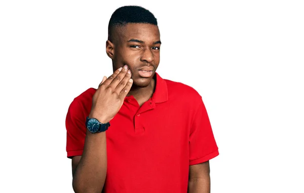Young African American Man Wearing Casual Red Shirt Touching Mouth — стокове фото