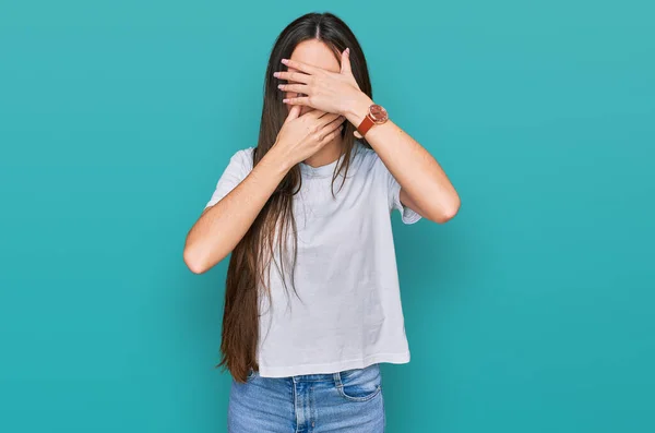 Young Hispanic Girl Wearing Casual White Shirt Covering Eyes Mouth — 图库照片