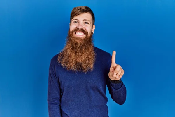 Redhead Man Long Beard Wearing Casual Blue Sweater Blue Background — Stok fotoğraf