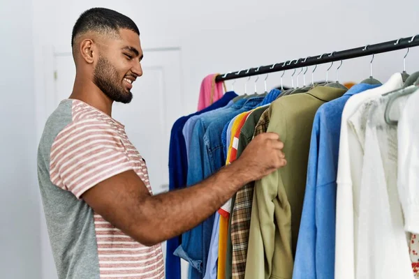 Young Arab Man Holding Shirt Shopping Clothing Store —  Fotos de Stock