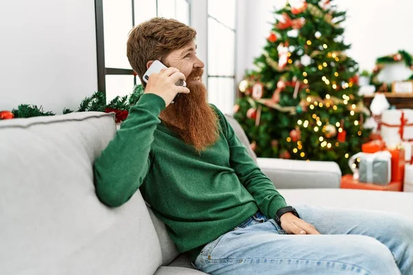 Young Redhead Man Talking Smartphone Sitting Christmas Tree Home — 스톡 사진