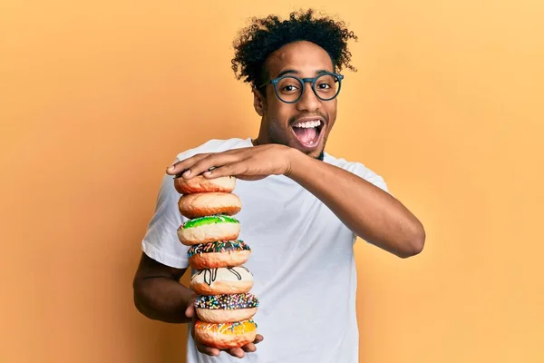Young African American Man Beard Holding Pile Tasty Colorful Doughnuts — Foto de Stock