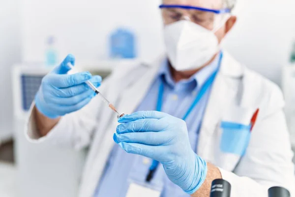 Middle Age Grey Haired Man Wearing Scientist Uniform Using Syringe — Stock Photo, Image