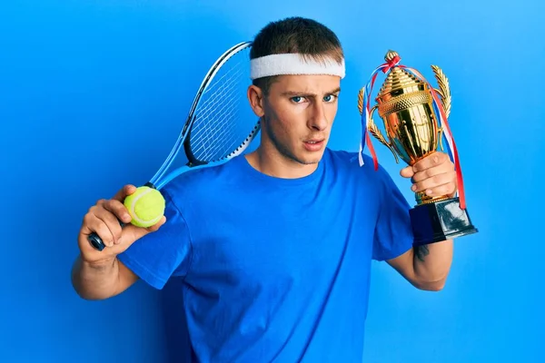 Young Caucasian Man Playing Tennis Holding Trophy Clueless Confused Expression — ストック写真