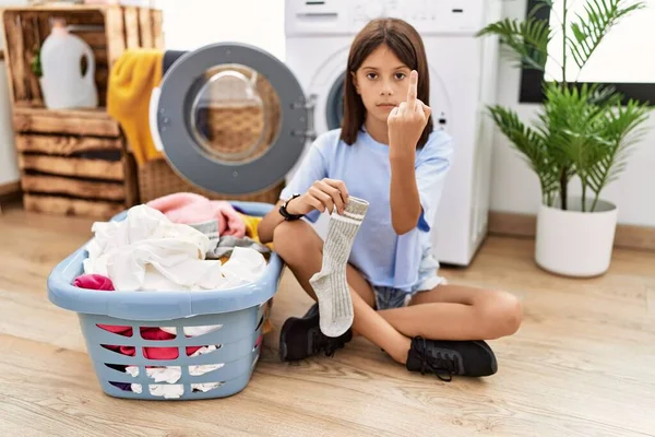 Young Hispanic Girl Doing Laundry Holding Socks Showing Middle Finger — ストック写真