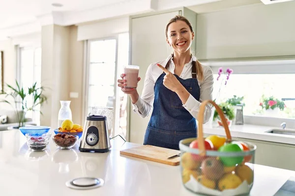 Beautiful Blonde Woman Wearing Apron Drinking Smoothie Kitchen Smiling Happy — Stockfoto